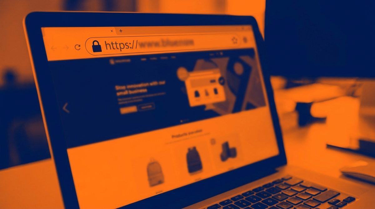 Close-up of a browser address bar showing a padlock icon and HTTPS address on a small business website displayed on a laptop screen