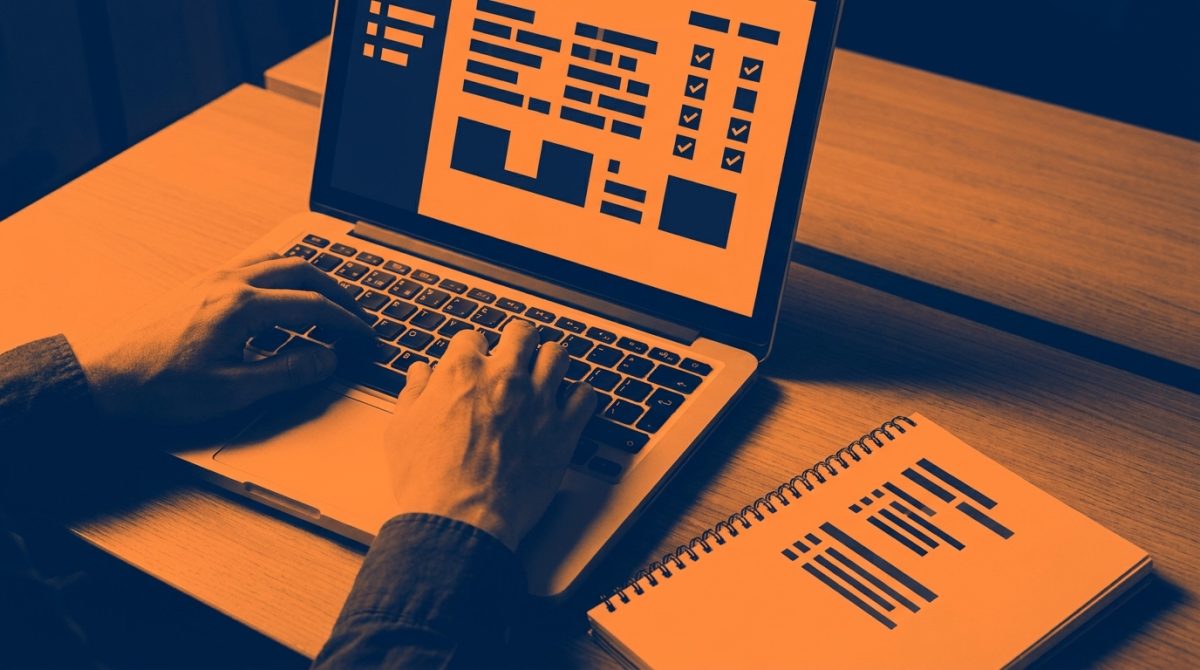 A person at a desk viewing Google's Rich Results Test on a laptop screen, with structured data validation results visible, a notepad with NAP details beside the keyboard
