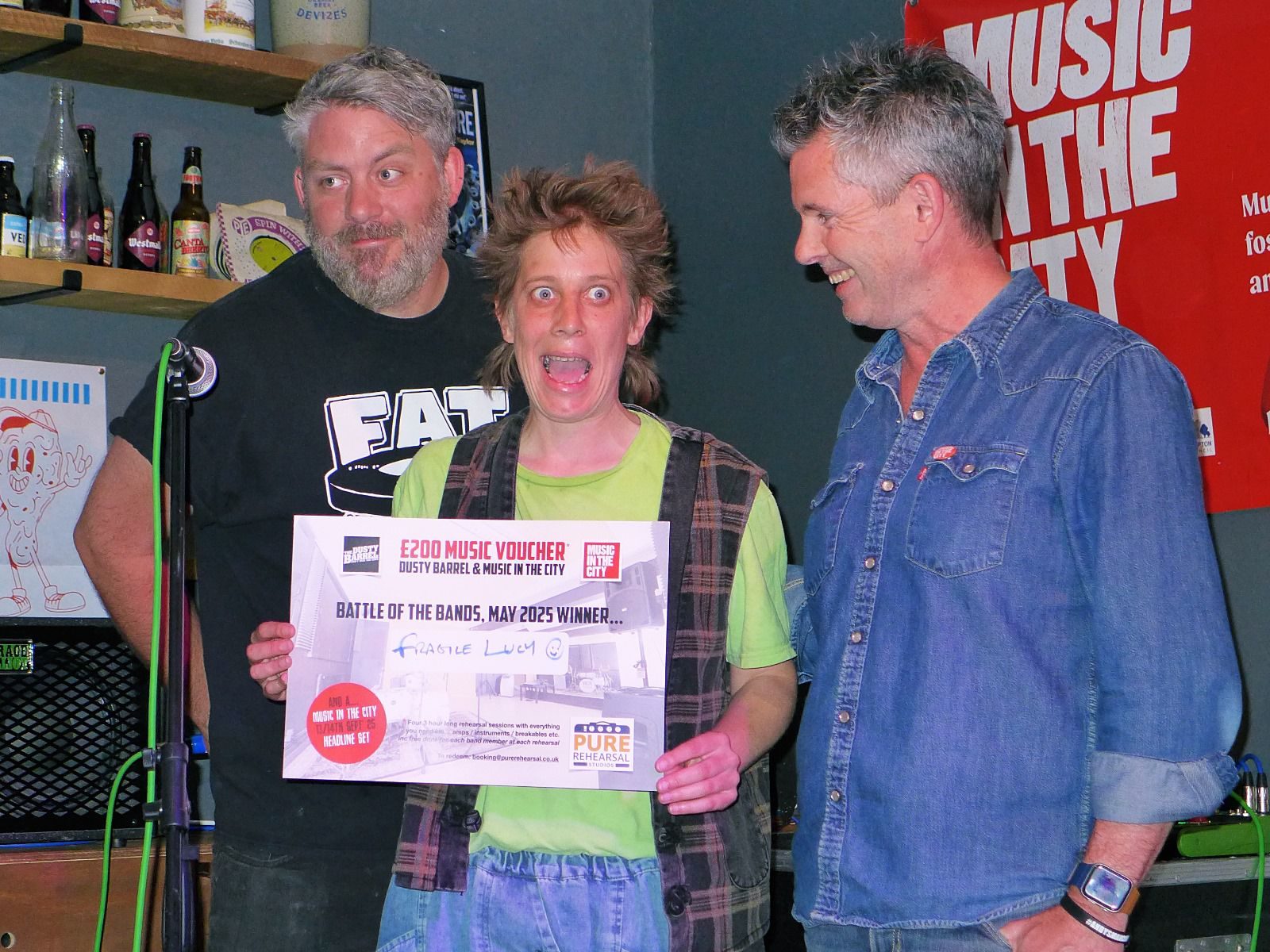Fragile Lucy collecting the Battle of the Bands prize