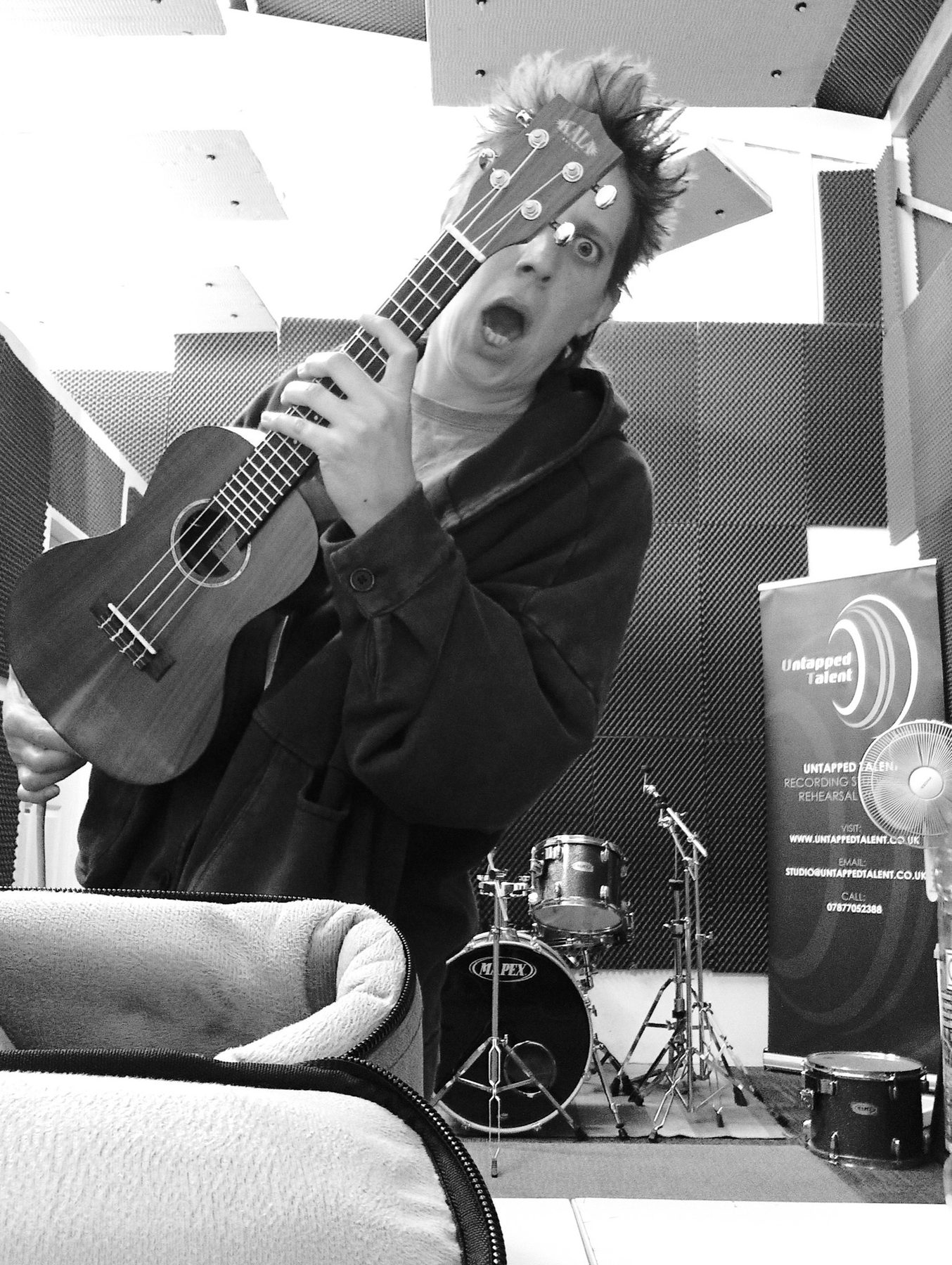 Fragile Lucy pulling a face with her ukulele in the rehearsal studio
