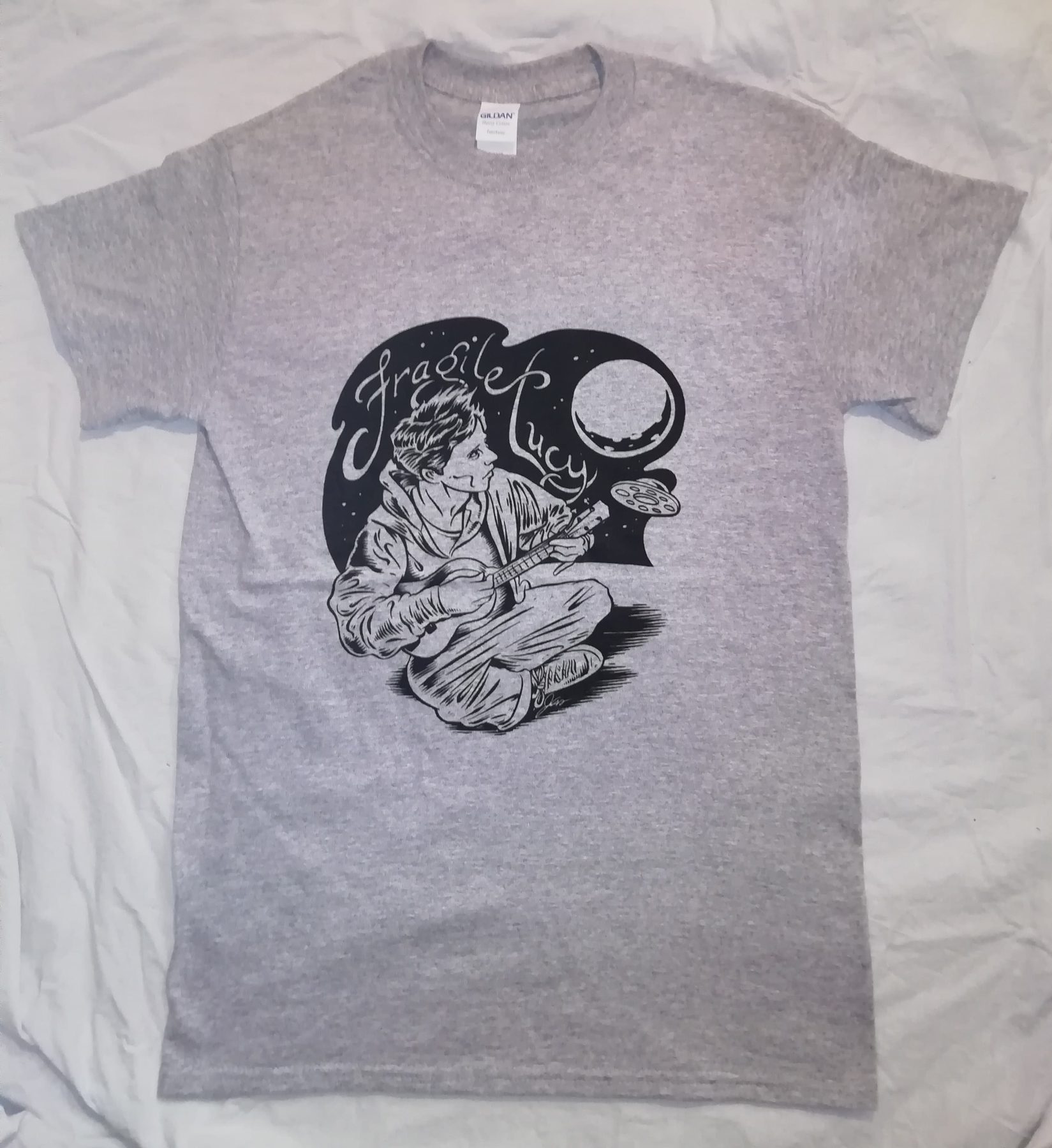 Grey Fragile Lucy t-shirt with the moon and ukulele artwork