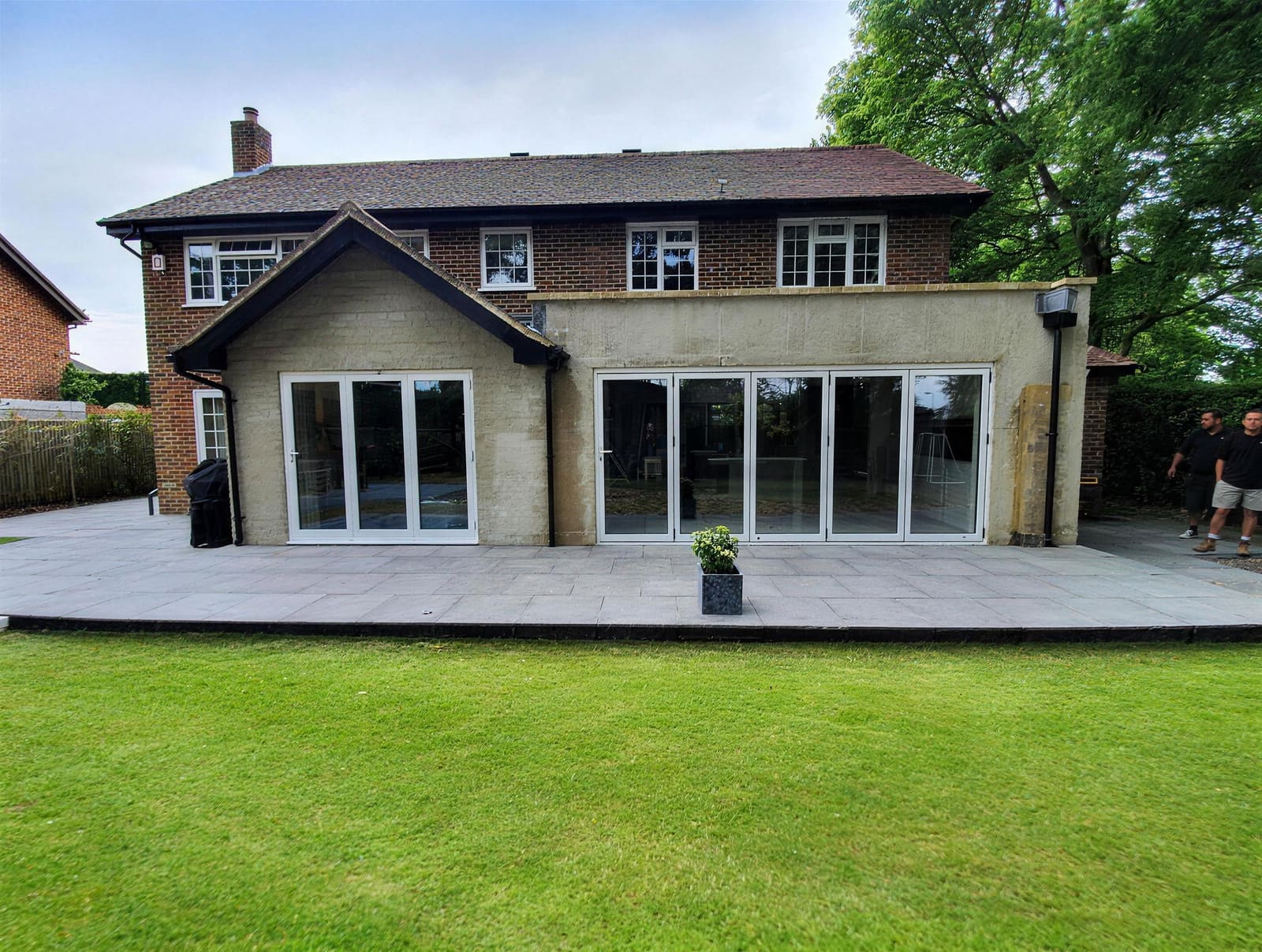 Finished side and rear extension at Burnham with bi-fold doors and new lawn